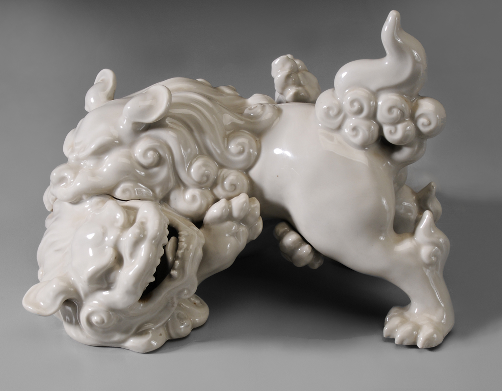 Appraisal: Pair Ceramic Frolicking Lions Chinese white glaze - x in