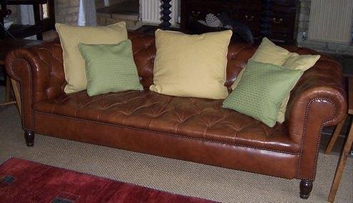 Appraisal: A leather button upholstered Chesterfield sofa on squat turned legs