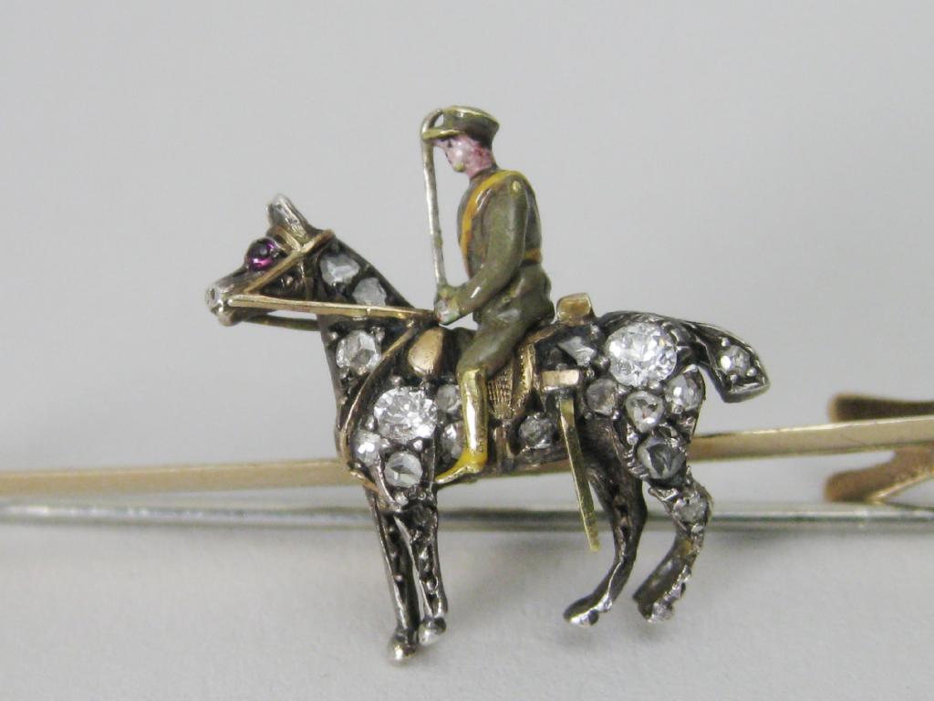 Appraisal: A gold Brooch with mounted WWI Cavalry Officer enamelled his