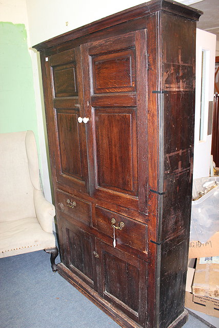 Appraisal: AN TH CENTURY OAK PANELLED CUPBOARD with cavetto cornice above