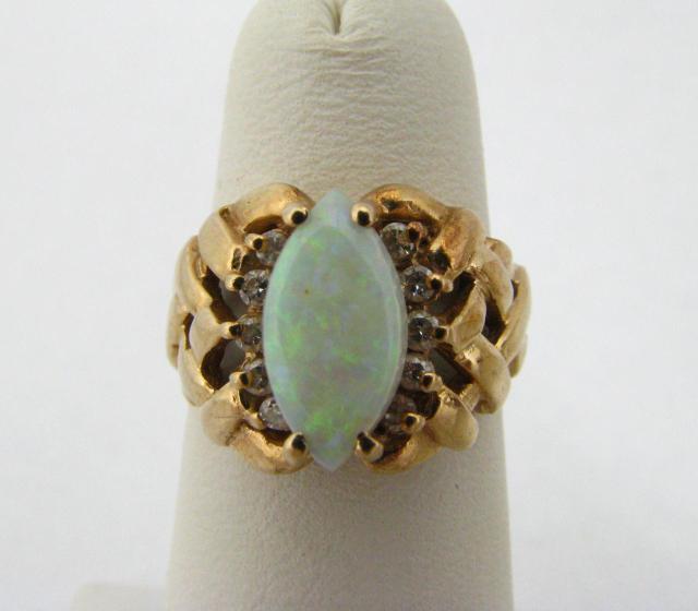 Appraisal: K Yellow gold ring with opal center stone and ten