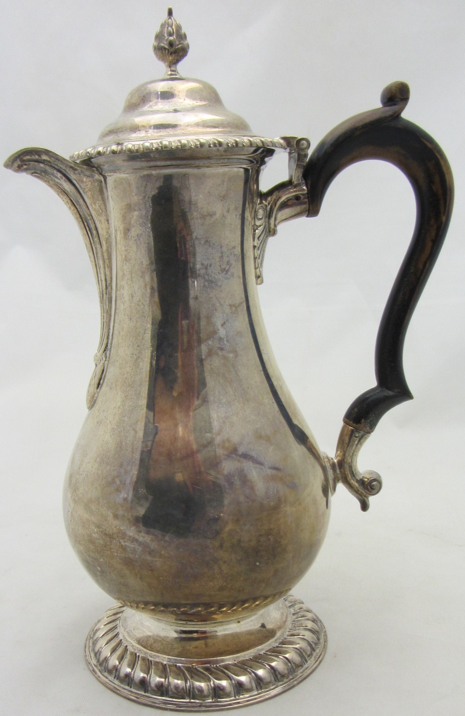 Appraisal: A silver hot water jug of pear shaped form decorated