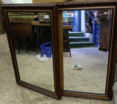 Appraisal: A pair of carved wooden framed mirrors