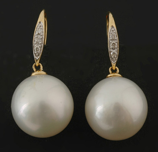 Appraisal: A pair of South Sea pearl earrings The round pearls