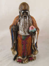 Appraisal: A ceramic figure of a sage with lotus impressed Chinese