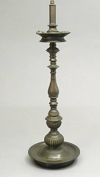 Appraisal: An Islamic brass oil lamp th century The multi-knopped gadrooned