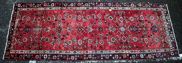 Appraisal: A HAMADAN RED GROUND SHORT RUNNER OR RUG with geometric