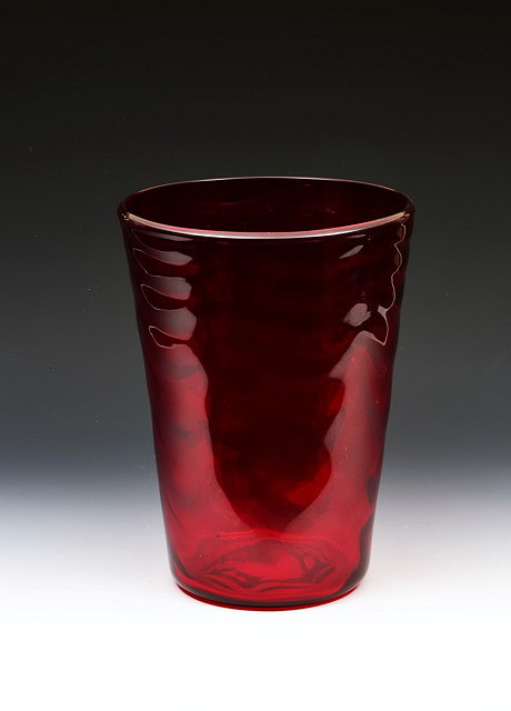 Appraisal: Whitefriars GlassVase wave-ribbed tumbler vase in ruby red glasspattern designed