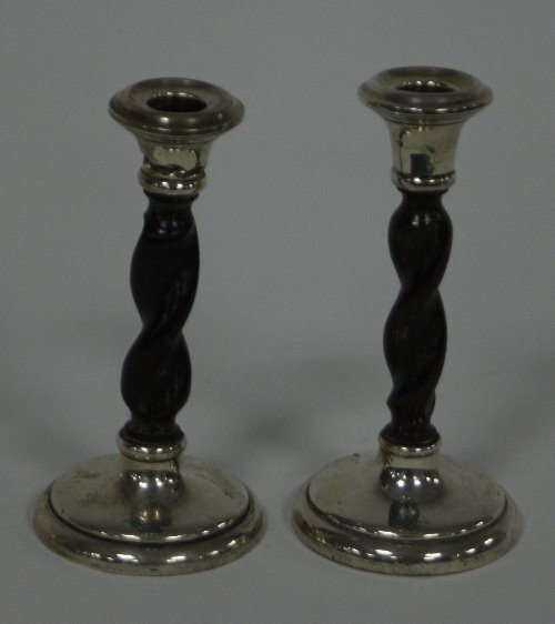 Appraisal: A pair of silver mounted candlesticks Birmingham the barley twist