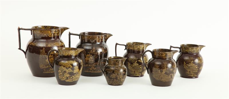 Appraisal: GROUP OF SEVEN STAFFORDSHIRE YELLOW-DECORATED BROWN-GLAZED PITCHERS to in Provenance