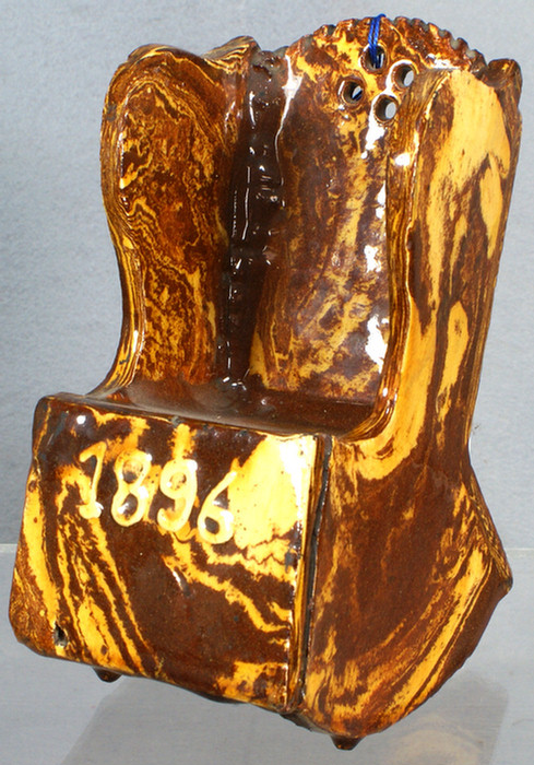 Appraisal: Brown and yellow glazed Bennington rocking chair dated h Estimate