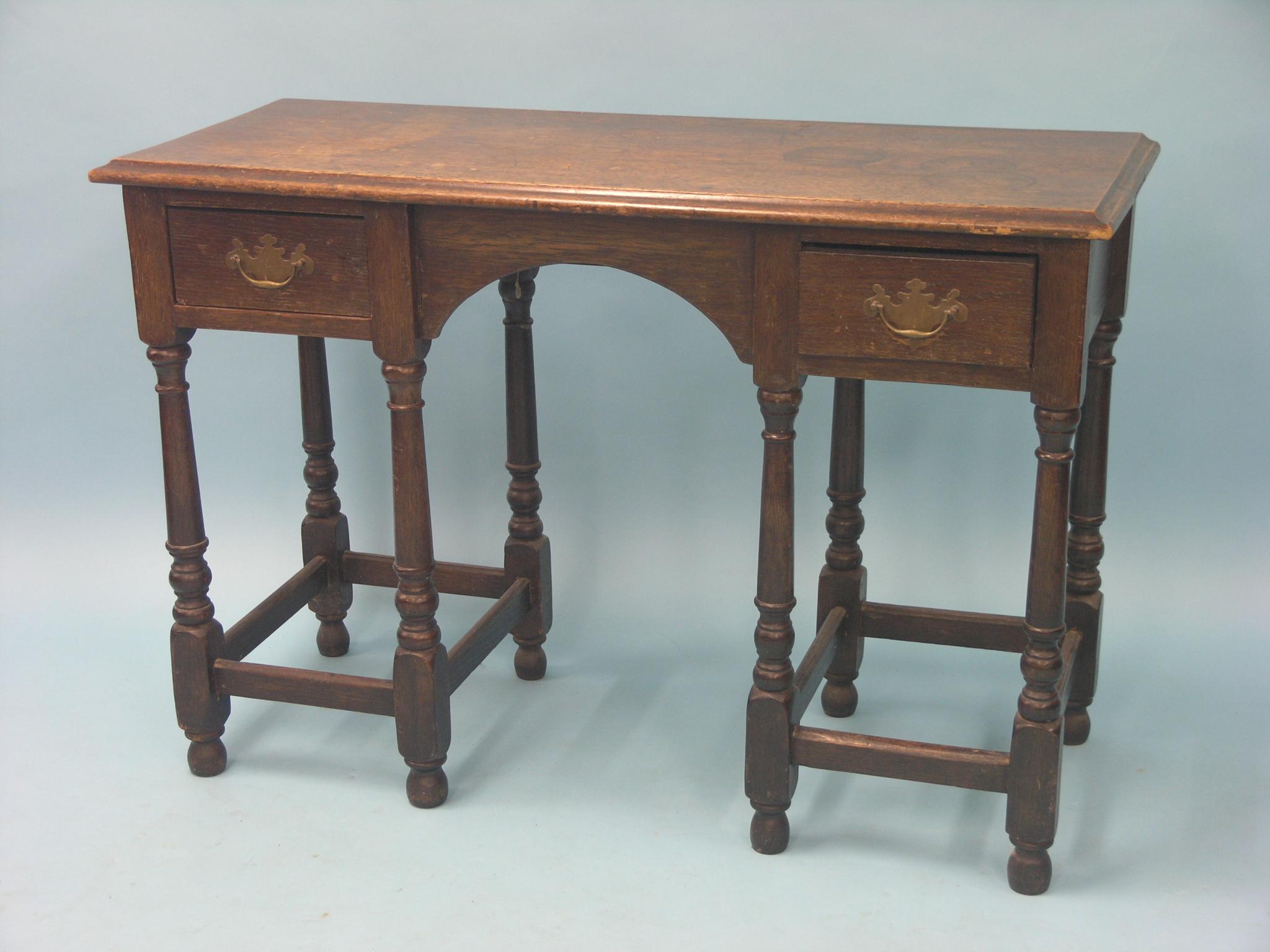 Appraisal: A solid dark oak writing table with walnut top open