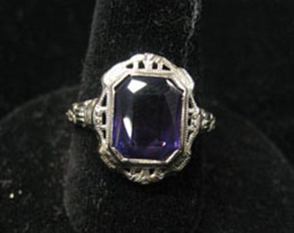 Appraisal: White gold ring with rectangular purple colored stone