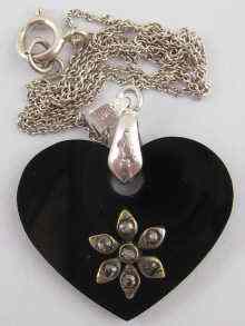 Appraisal: A white metal tests silver heart shaped pendant set with