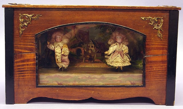 Appraisal: Automaton Diorama Pair of bisque head dolls - boy and