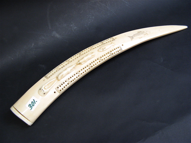 Appraisal: WALRUS IVORY CRIBBAGE BOARD having raised carved figures of walrus