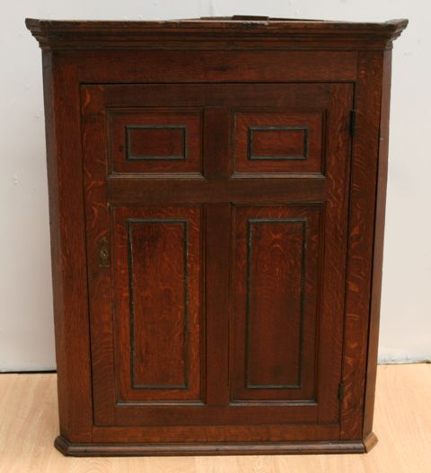 Appraisal: A George III oak hanging corner cupboard cm wide cm