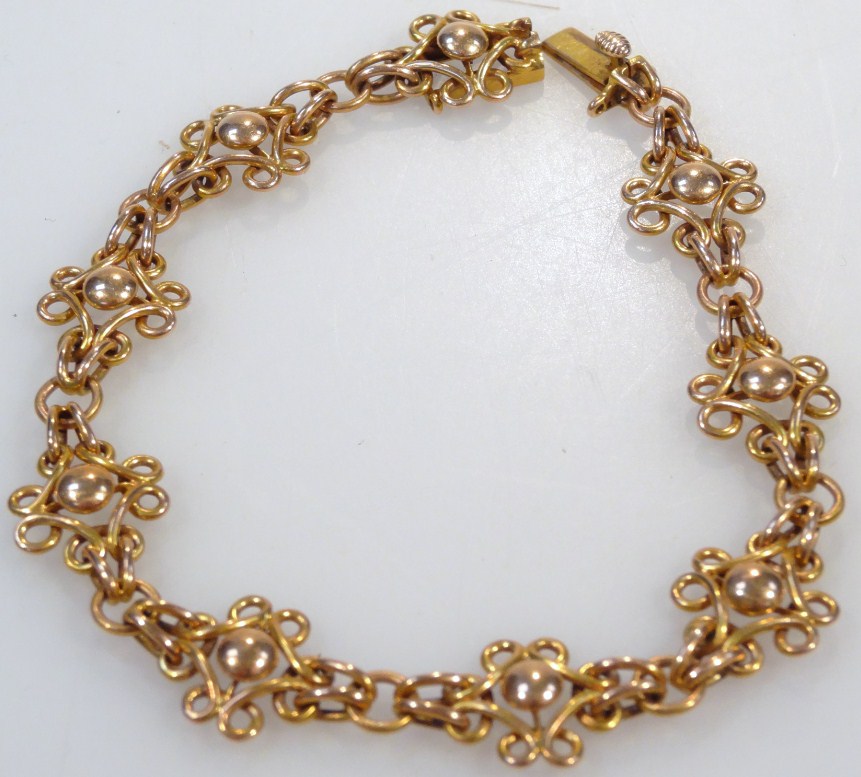 Appraisal: A fancy link bracelet set with pierced orb pieces with