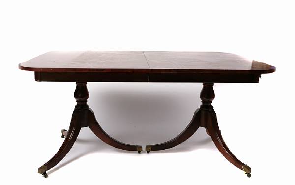 Appraisal: An English mahogany dining suite comprising an extension double pedestal