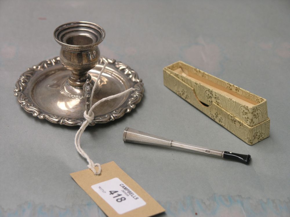 Appraisal: A continental white metal chamberstick with cast shell border and