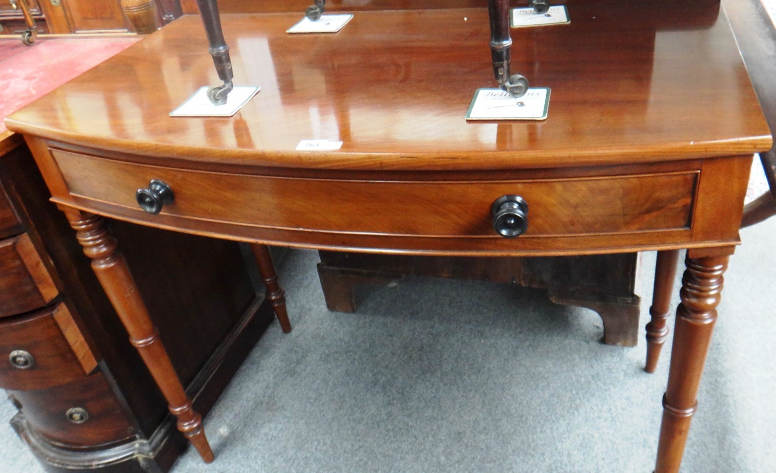 Appraisal: A th century mahogany bowfront writing table with single frieze