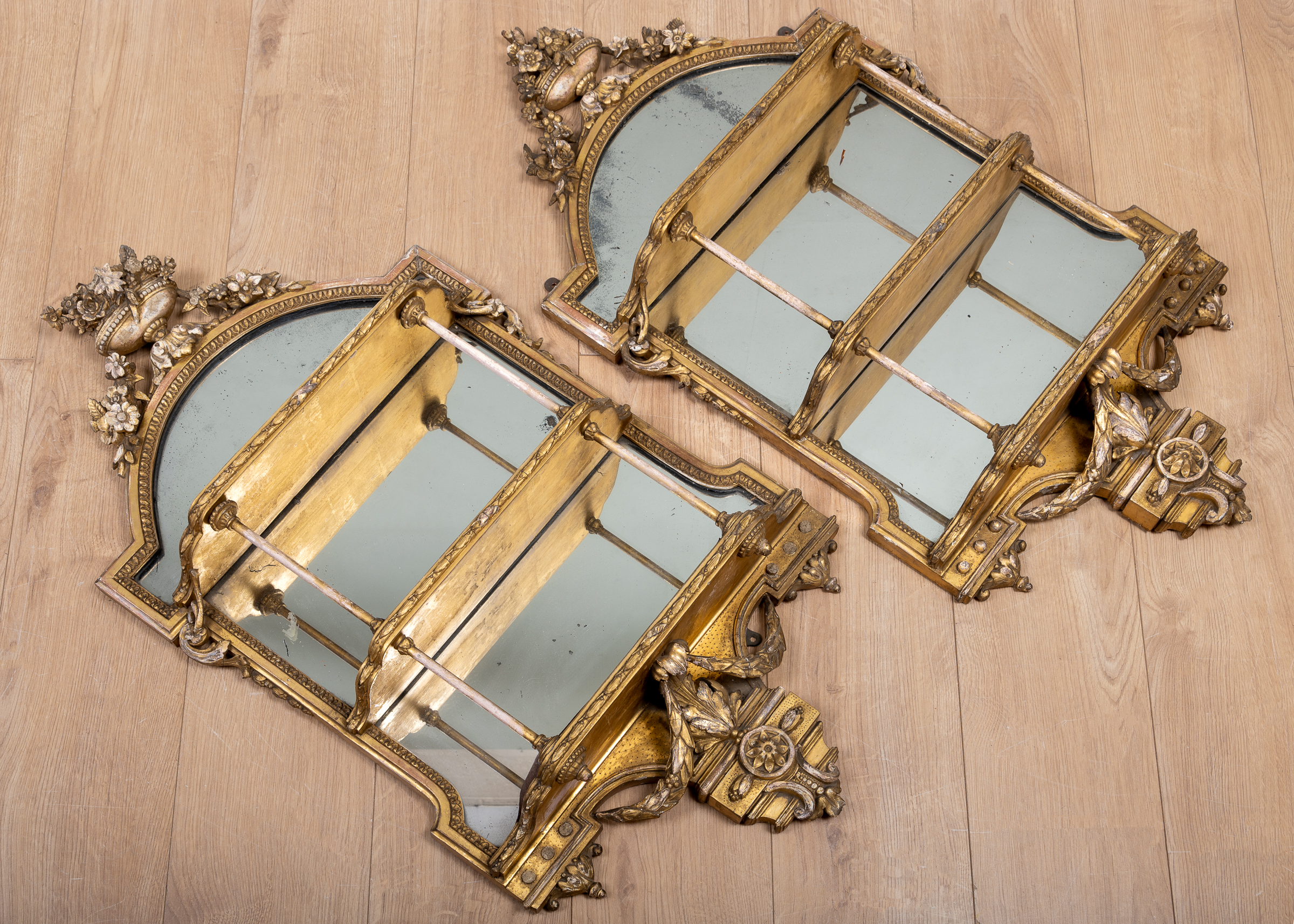 Appraisal: A pair of Victorian gilt gesso mirrored three-tier wall shelves