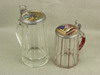 Appraisal: STEINS - Two clear glass paneled design steins with pewter