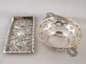 Appraisal: A Victorian silver pin tray heavily embossed with floral scrolling