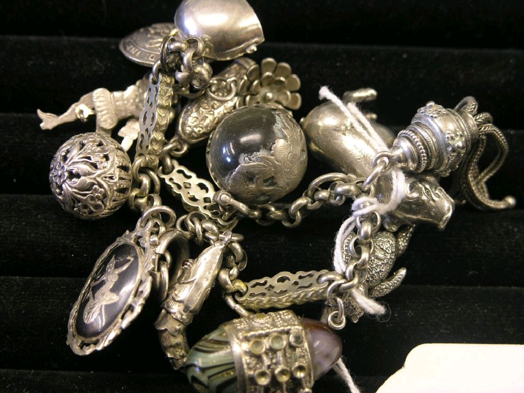 Appraisal: A charm bracelet thirteen white metal silver plated charms including