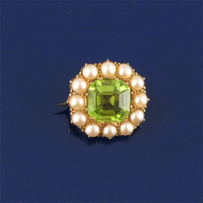 Appraisal: A peridot mounted ct gold brooch within a cluster of