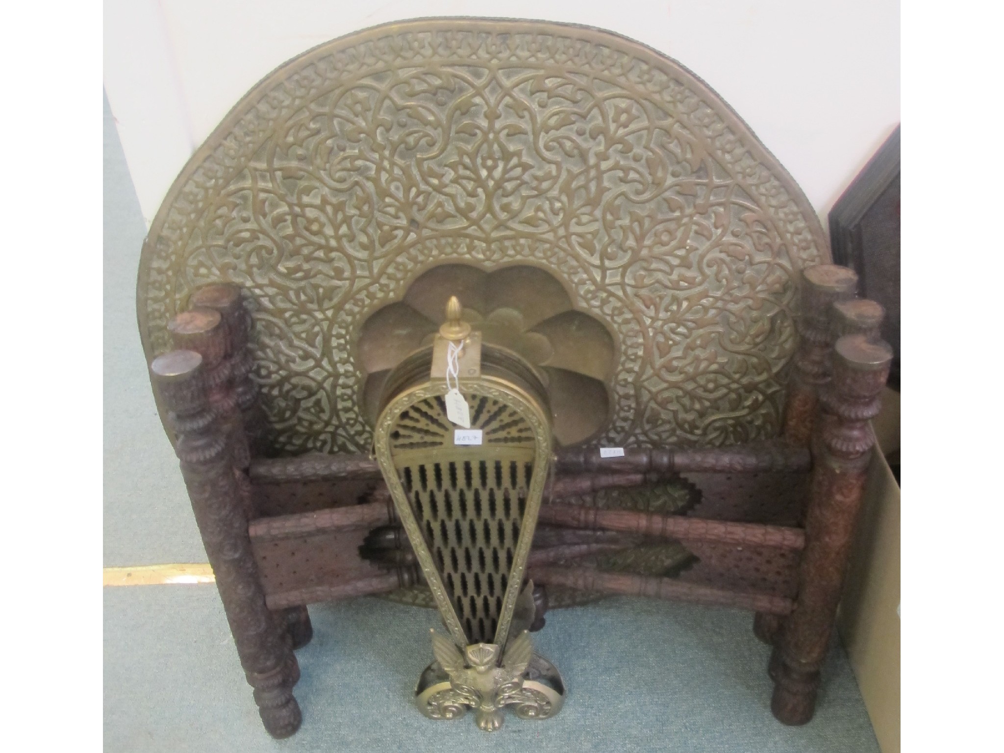 Appraisal: An Eastern table and brass fire fender