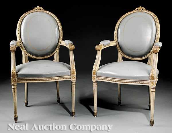 Appraisal: A Pair of Louis XVI-Style Painted Fauteuils guilloche carved and