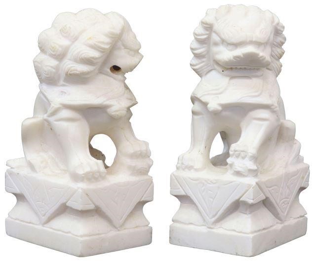 Appraisal: pair Chinese carved white marble foo lions rising on pedestal