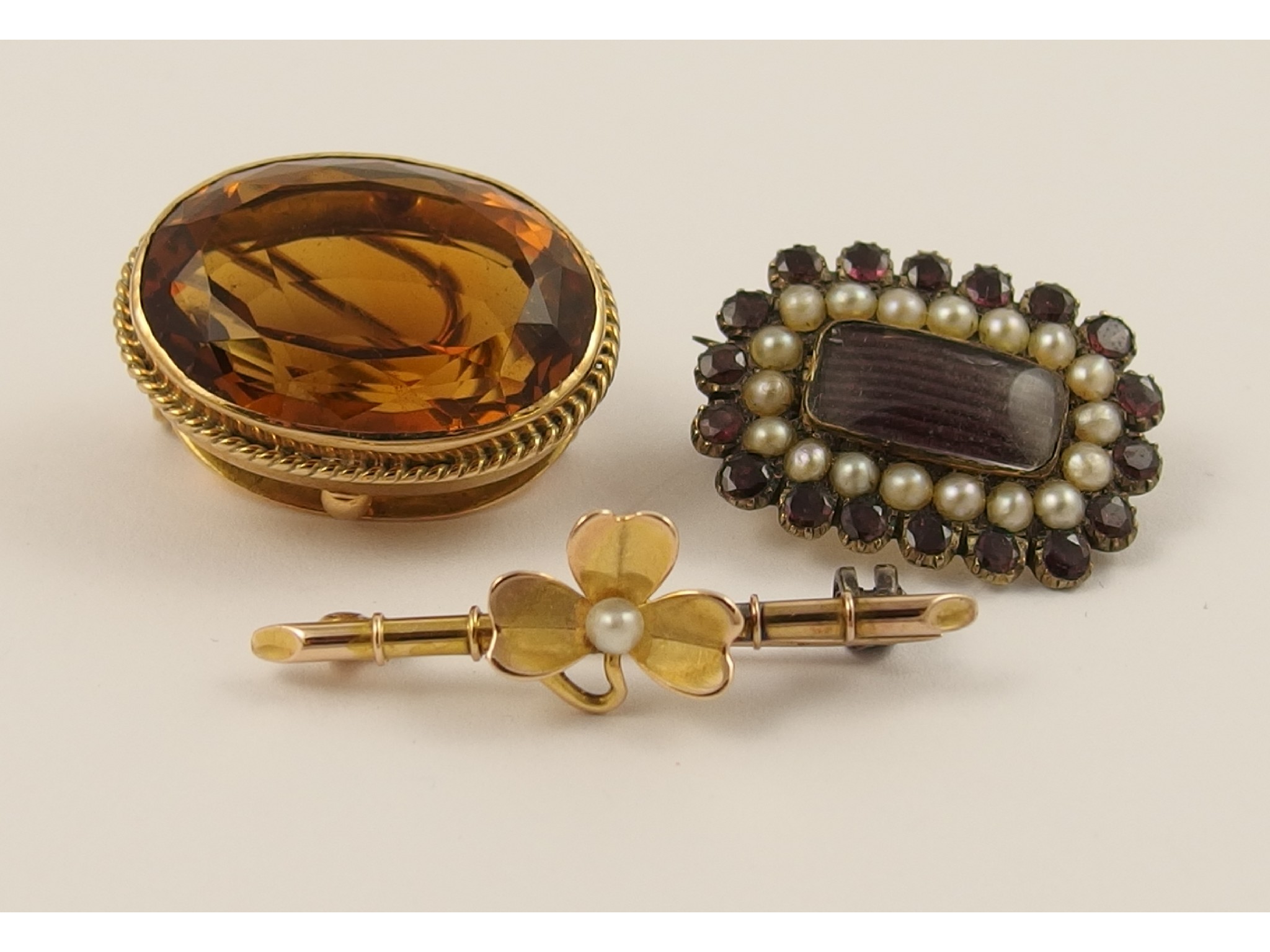 Appraisal: A garnet and pearl mourning brooch together with two others