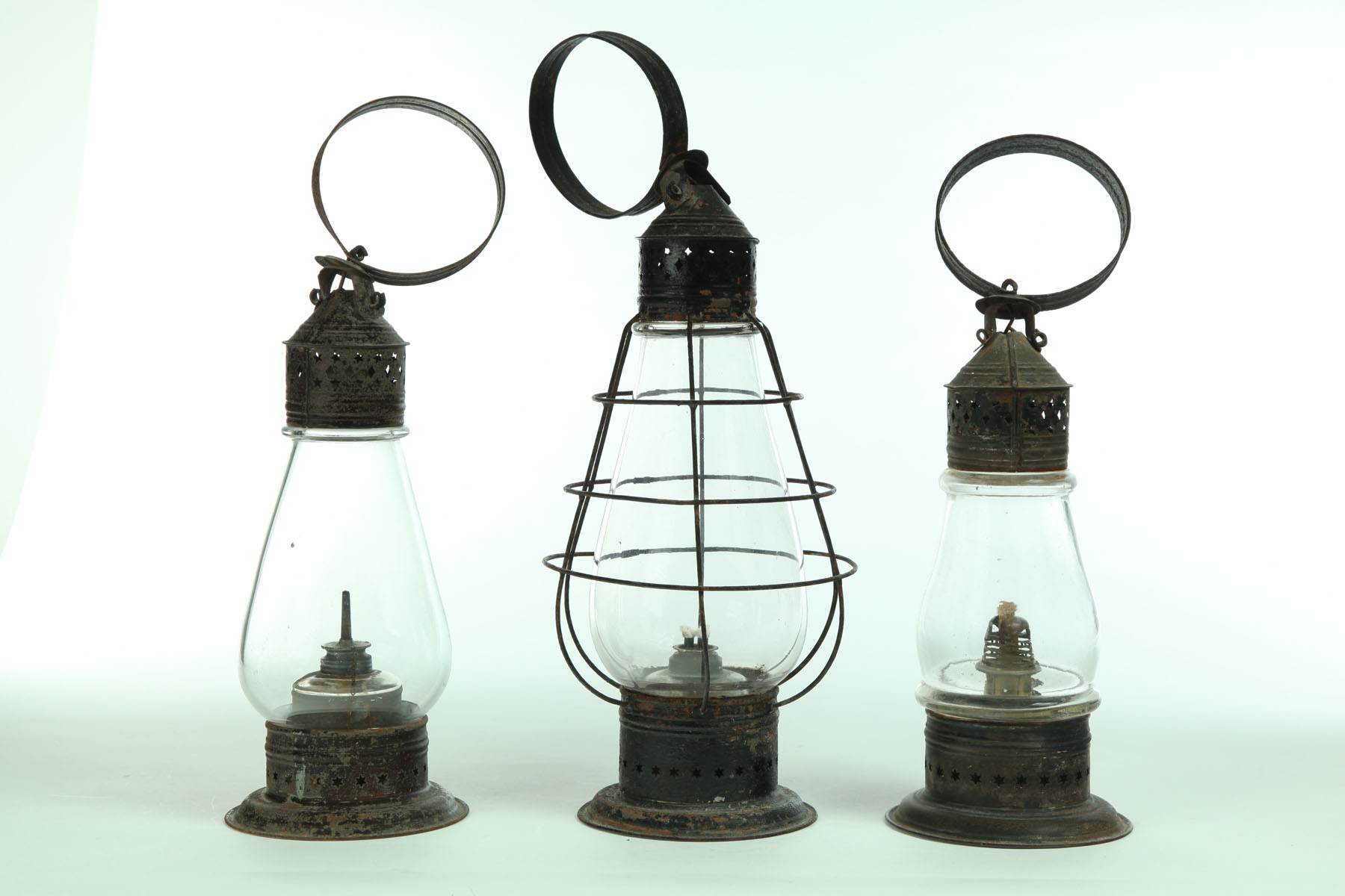 Appraisal: THREE LANTERNS American mid th century tin and glass Tear