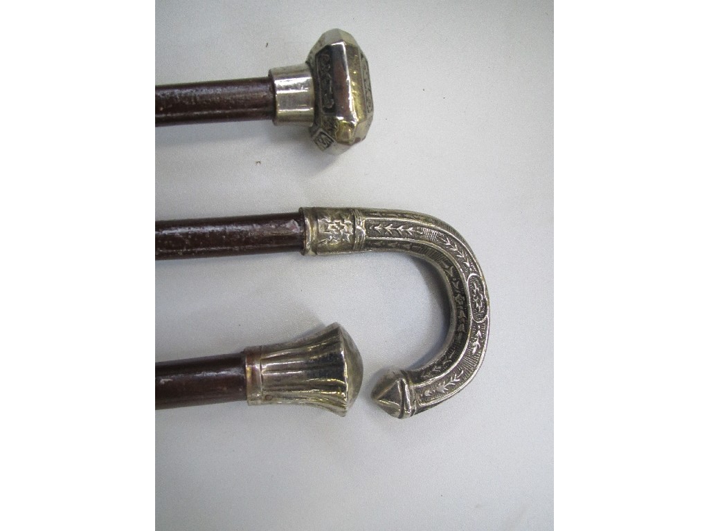 Appraisal: Lot comprising three white metal topped walking sticks