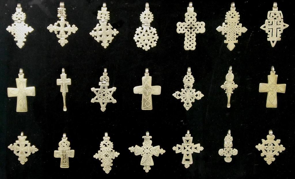 Appraisal: Collection of twenty-one ethnic African white metal cruciform pendants within