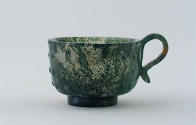 Appraisal: A Chinese moss agate cup the body carved with small