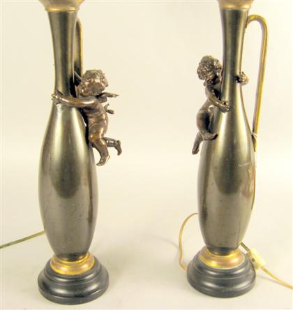 Appraisal: Pair of patinated metal ewers The slender baluster form with