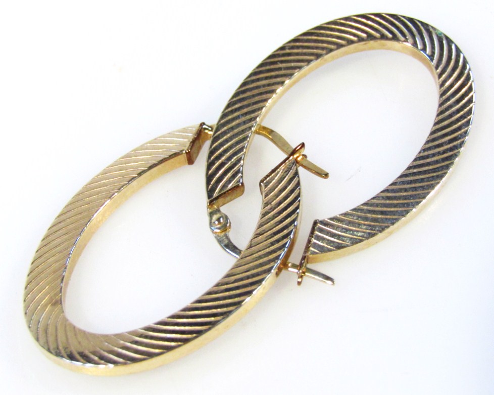 Appraisal: A pair of Continental hooped earrings of part textured outline