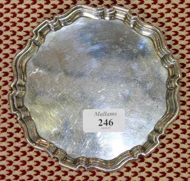 Appraisal: A SMALL SILVER CARD TRAY of circular form with raised