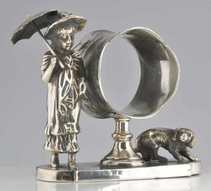 Appraisal: Kate Greenaway Figural Napkin Ring Lady with parasol and dog