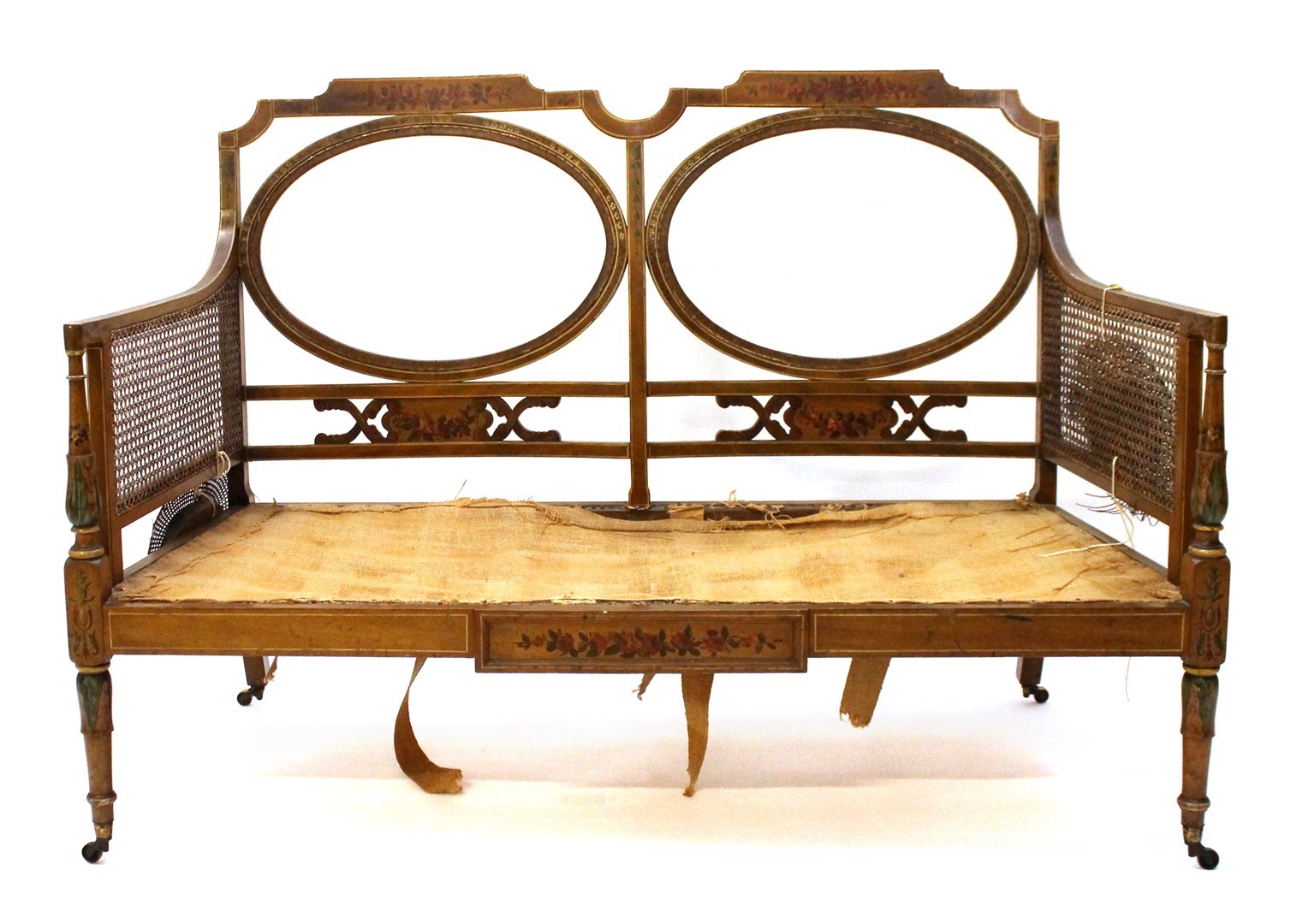 Appraisal: A late th century floral painted satinwood sofa with double