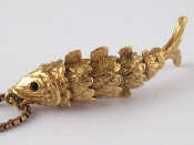 Appraisal: A carat gold articulated pendant designed as a fish on