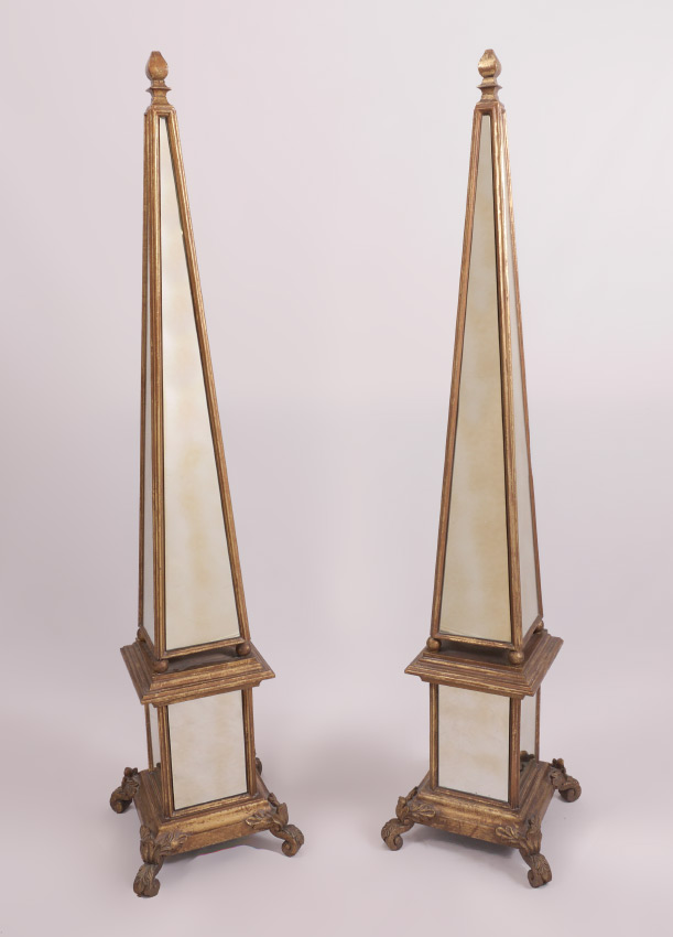 Appraisal: PAIR OF LARGE MIRRORED OBELISKS Giltwood frames pyramid top over