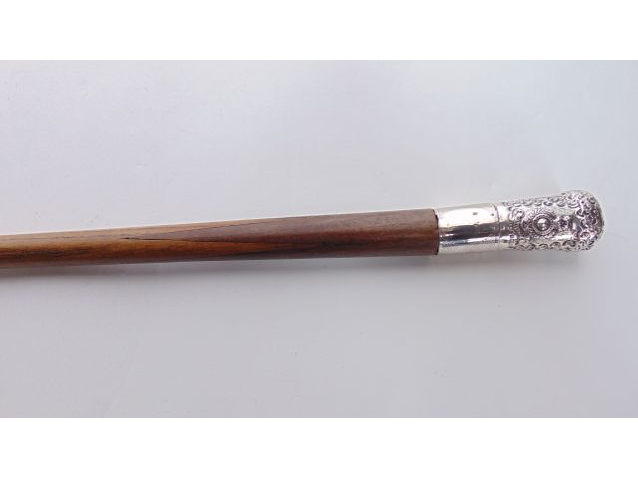 Appraisal: A timber walking cane terminating in a silver knop with