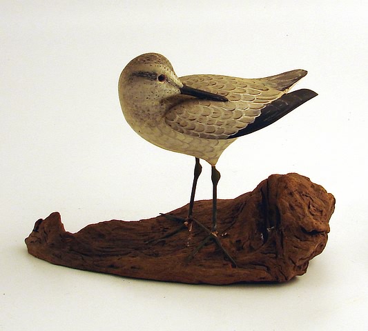 Appraisal: Decorative sandpiper carving in sleeping position metal legs attached on