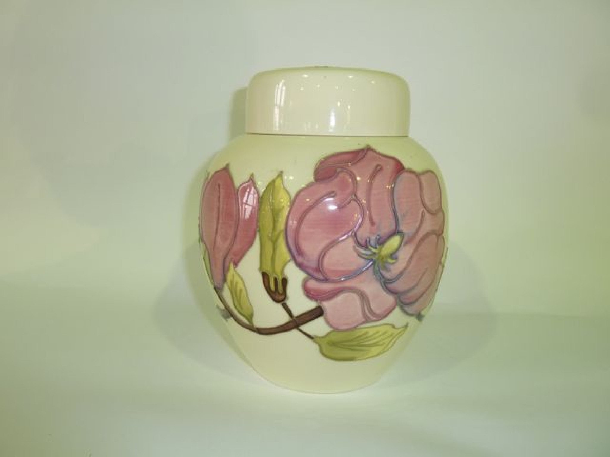 Appraisal: A Moorcroft cream ground Magnolia pattern ginger jar and cover