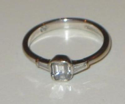 Appraisal: A SOLITAIRE DIAMOND RING the emerald cut diamond approximately cts