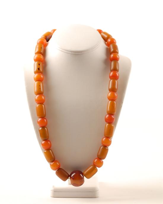 Appraisal: A Large Opaque Amber Bead Necklace with alternating spherical and